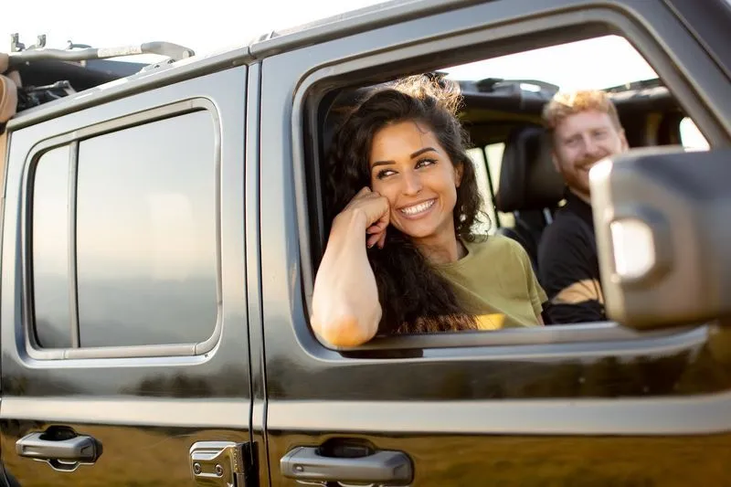 Happy couple driving in car